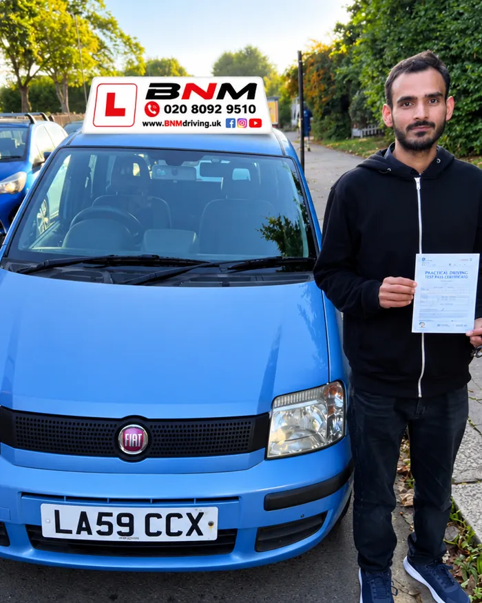 Learner holding a driving test pass certificate beside a blue BNM learner car