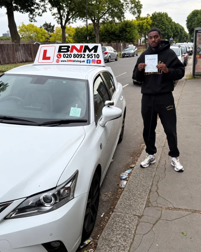 Learner with a pass certificate next to a white BNM Driving School car