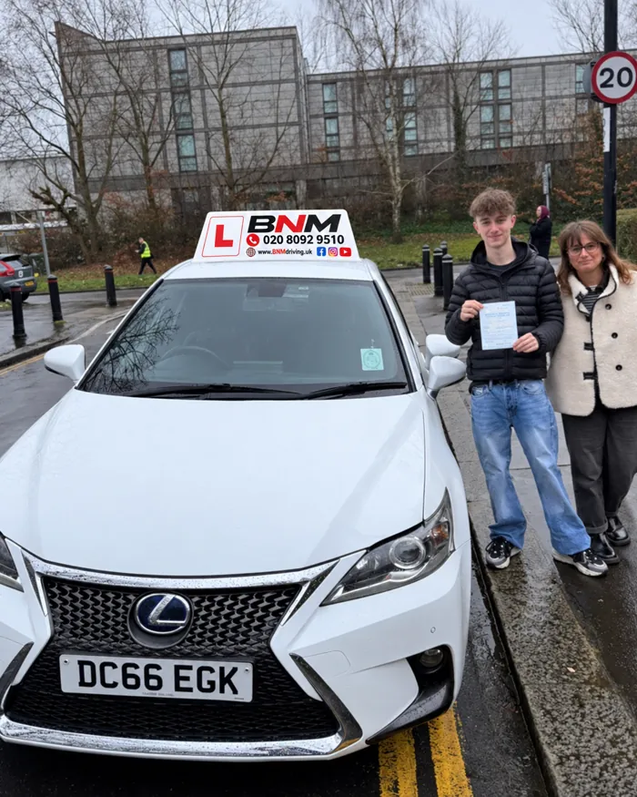 New driver and family member celebrating a test pass beside a BNM Lexus