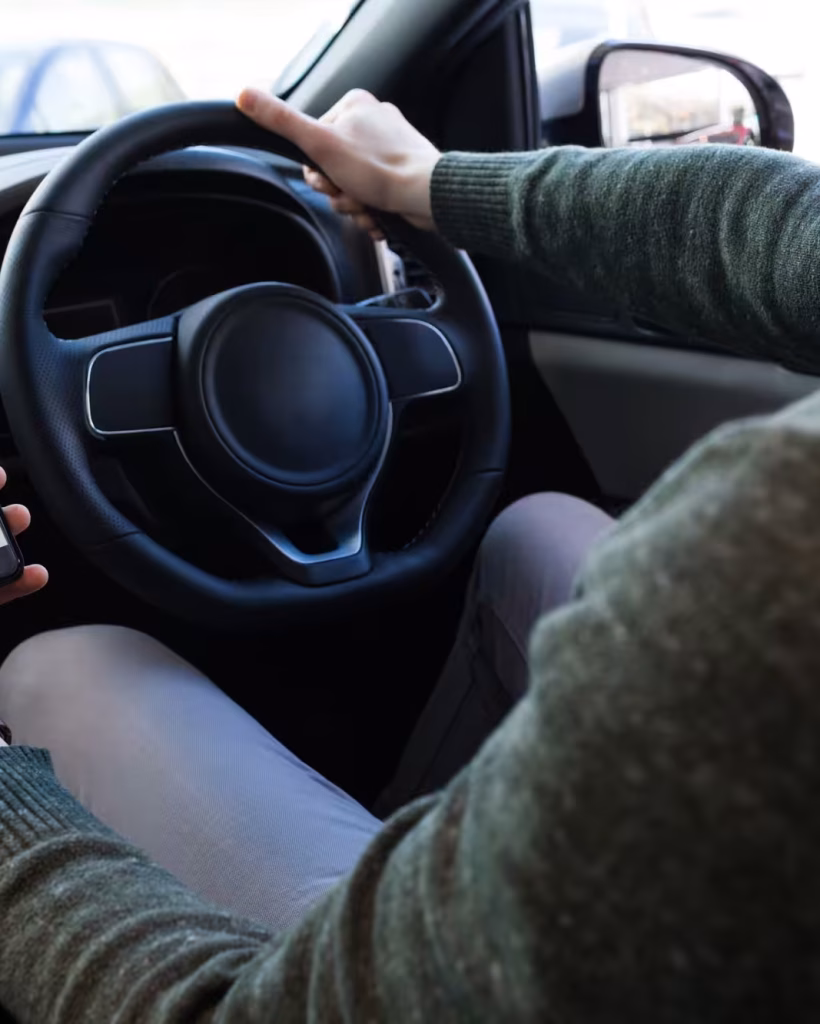 man-using-smartphone-while-driving-car.jpg